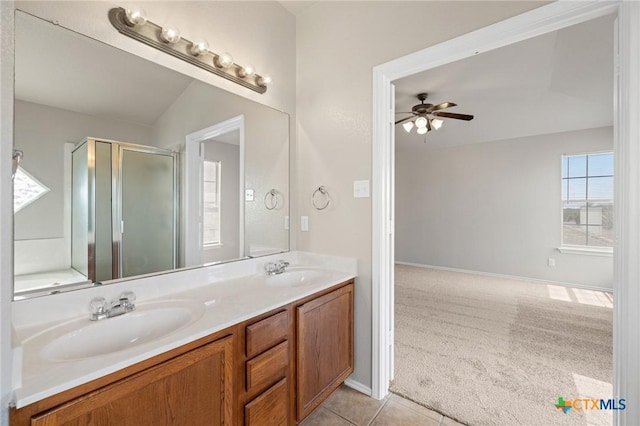 full bath with ceiling fan, a sink, a shower stall, and double vanity