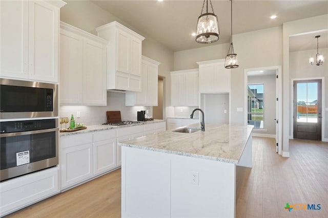4007 Aerie St, Salado, TX 76571 - kitchen featuring stainless steel appliances, a chandelier, tasteful backsplash, white cabinets, and recessed lighting