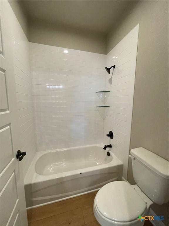 full bath featuring shower / bathing tub combination, toilet, and wood finished floors