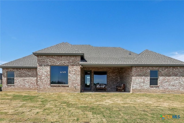 4007 Aerie St, Salado, TX 76571 - back of property with roof with shingles, brick siding, and a lawn