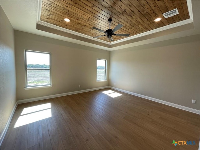 unfurnished room with a tray ceiling, wood ceiling, visible vents, and baseboards