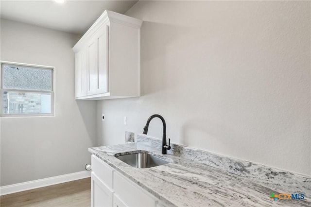 4007 Aerie St, Salado, TX 76571 - laundry area with cabinet space, light wood finished floors, electric dryer hookup, and hookup for a washing machine