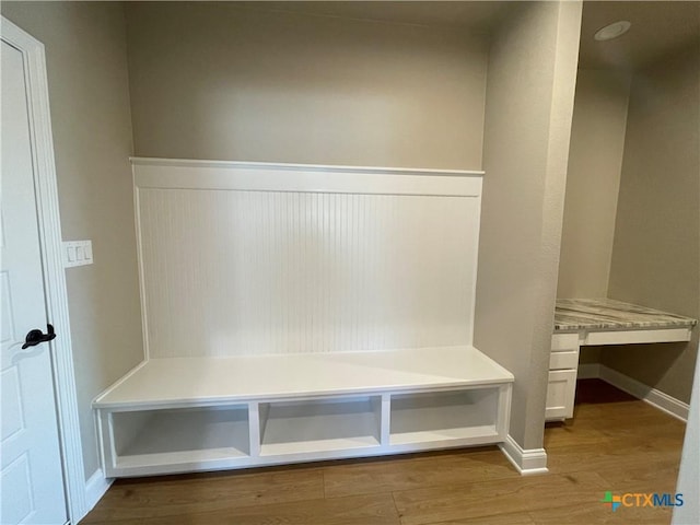 mudroom with baseboards and wood finished floors