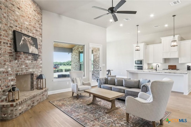 4007 Aerie St, Salado, TX 76571 - living room featuring a ceiling fan, light wood-type flooring, recessed lighting, and a fireplace