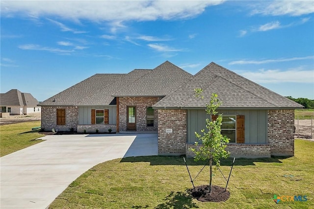 4007 Aerie St, Salado, TX 76571 - view of front facade featuring brick siding, a shingled roof, driveway, and a front yard