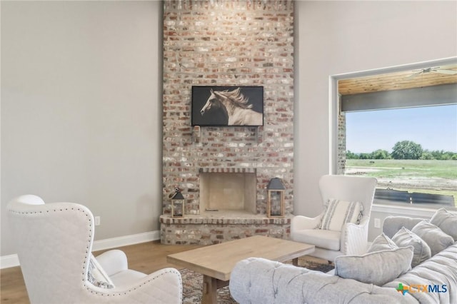 4007 Aerie St, Salado, TX 76571 - living area featuring wood finished floors and a brick fireplace
