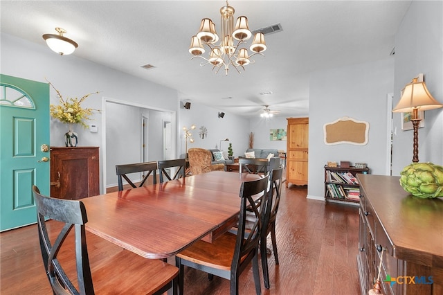 dining area with ceiling fan with notable chandelier, visible vents, baseboards, and dark wood finished floors
