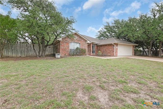 ranch-style home with concrete driveway, a front yard, an attached garage, fence, and brick siding