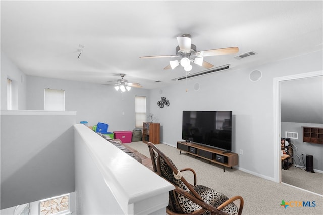 carpeted living area with visible vents and ceiling fan