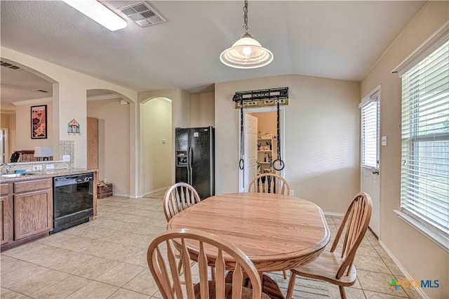 10016 Smock Mill Ln, Temple, TX 76502 - dining area featuring light tile patterned floors, arched walkways, and vaulted ceiling
