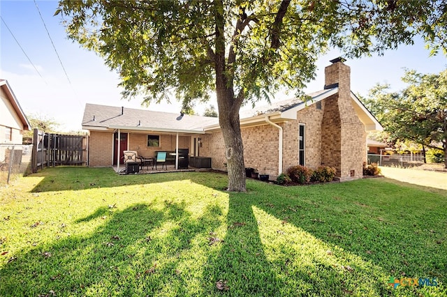 rear view of house with a yard