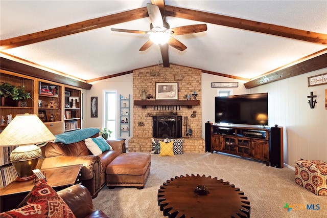 carpeted living room featuring a brick fireplace, lofted ceiling with beams, and ceiling fan