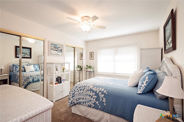 carpeted bedroom with a textured ceiling and ceiling fan