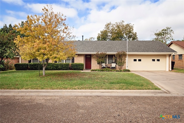 view of front of home featuring a garage and a front yard