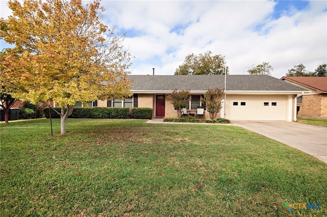 view of front of property featuring a garage and a front yard