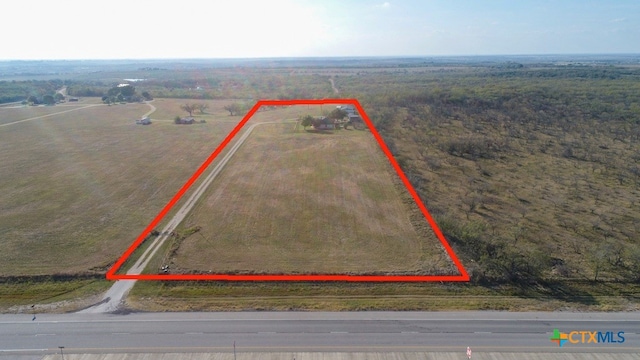 birds eye view of property with a rural view