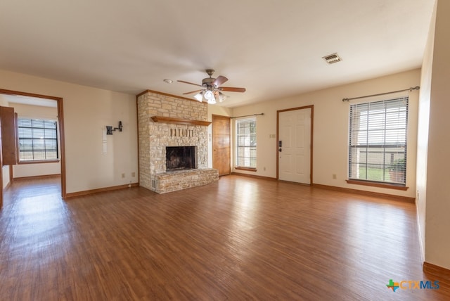 unfurnished living room featuring a fireplace, wood-type flooring, and ceiling fan