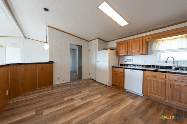 kitchen with ornamental molding, white appliances, dark wood-type flooring, sink, and hanging light fixtures