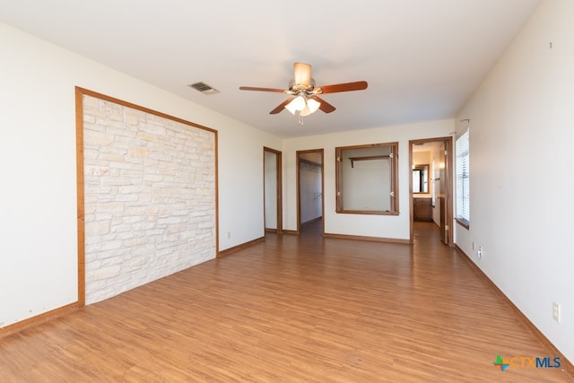 unfurnished room with ceiling fan and hardwood / wood-style flooring