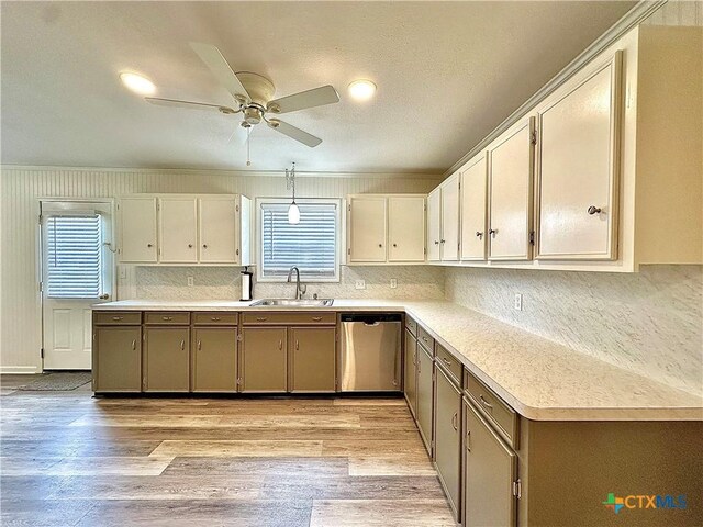 3301 Cypress St, Victoria, TX 77901 - kitchen with stainless steel dishwasher, a sink, light countertops, decorative backsplash, and a ceiling fan