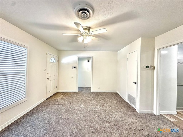 3301 Cypress St, Victoria, TX 77901 - carpeted spare room with ceiling fan, baseboards, and a textured ceiling