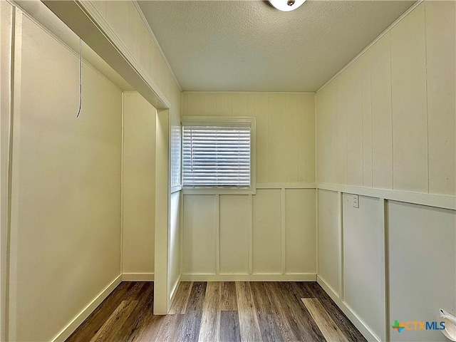 3301 Cypress St, Victoria, TX 77901 - spare room with wood finished floors, a decorative wall, and a textured ceiling