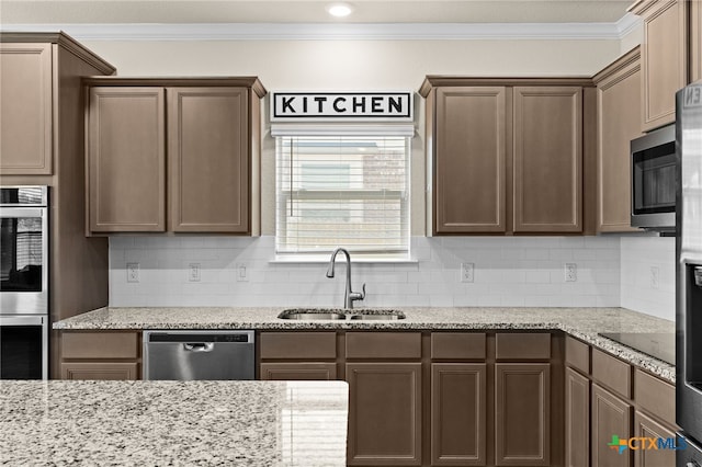 1203 Roma St, Harker Heights, TX 76548 - kitchen featuring appliances with stainless steel finishes, a sink, crown molding, decorative backsplash, and light stone countertops