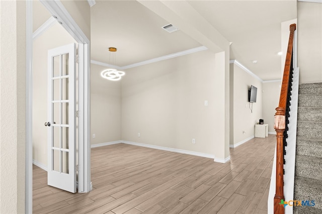 1203 Roma St, Harker Heights, TX 76548 - spare room featuring light wood-style flooring, crown molding, stairs, and baseboards