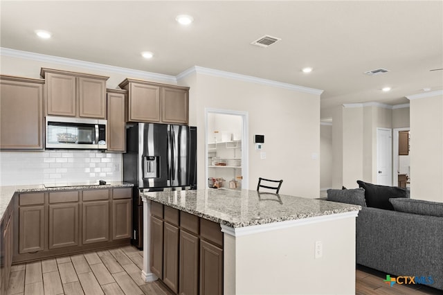 1203 Roma St, Harker Heights, TX 76548 - kitchen with black appliances, light wood-style floors, light stone counters, backsplash, and recessed lighting