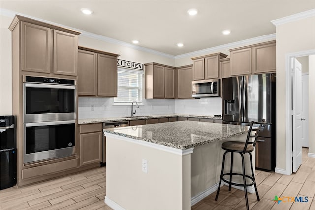 1203 Roma St, Harker Heights, TX 76548 - kitchen featuring stainless steel appliances, a sink, wood tiled floors, a center island, and crown molding