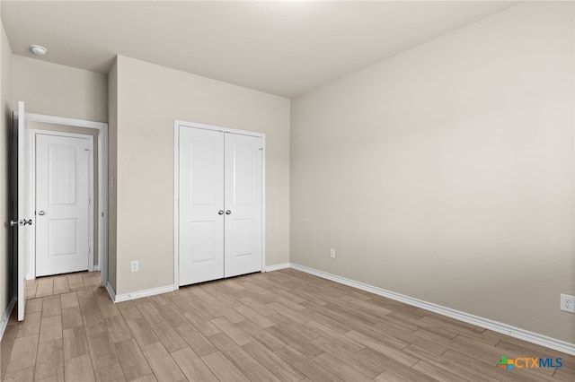 1203 Roma St, Harker Heights, TX 76548 - unfurnished bedroom with baseboards, light wood-style flooring, and a closet