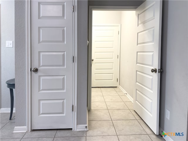 hallway with light tile patterned floors