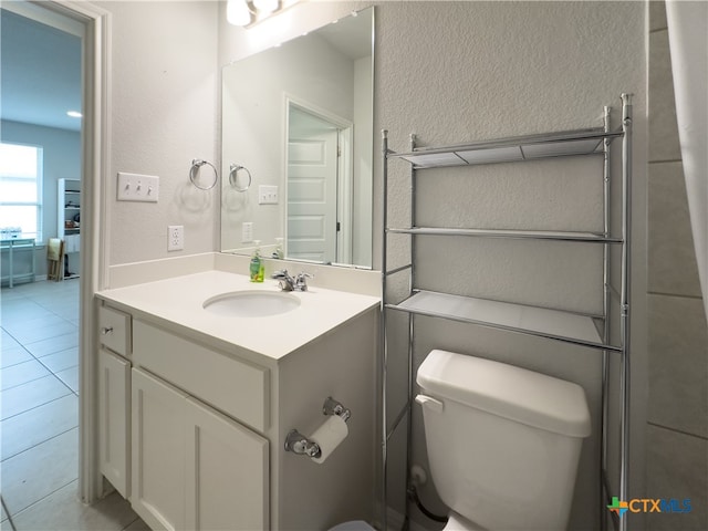 bathroom featuring tile patterned floors, vanity, and toilet