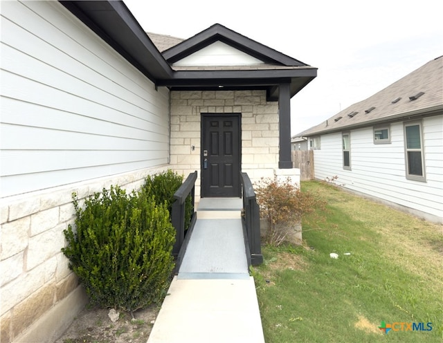 property entrance with a yard