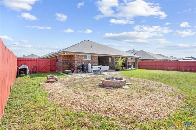 5907 Verde Dr, Killeen, TX 76549 - back of house with a fire pit, brick siding, and a patio area
