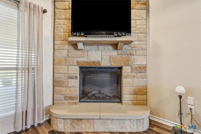 5907 Verde Dr, Killeen, TX 76549 - detailed view of wood finished floors, baseboards, and a fireplace