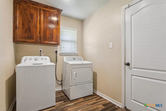 5907 Verde Dr, Killeen, TX 76549 - laundry area featuring cabinet space, washing machine and clothes dryer, dark wood-style floors, baseboards, and a textured wall