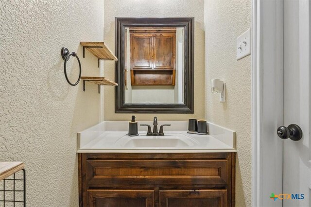 5907 Verde Dr, Killeen, TX 76549 - bathroom featuring a textured wall and vanity