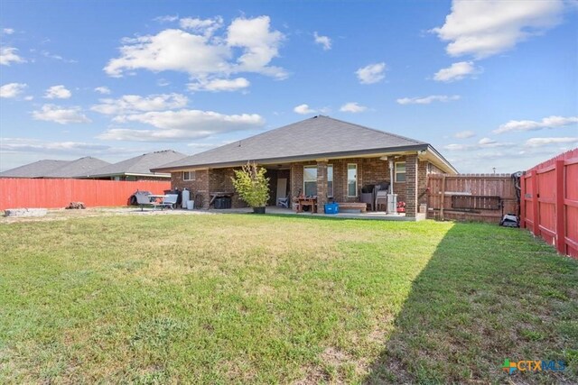 5907 Verde Dr, Killeen, TX 76549 - rear view of property featuring a patio area and brick siding