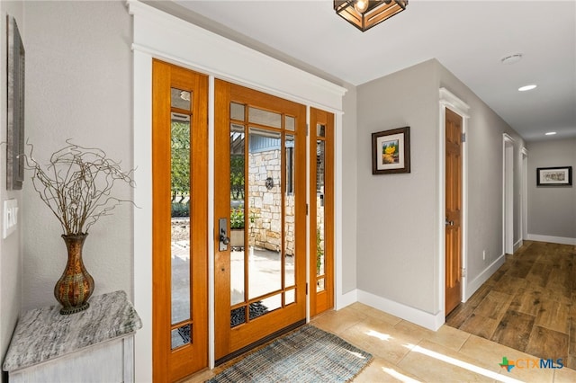 entrance foyer with baseboards and recessed lighting