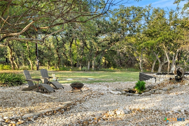 view of yard with an outdoor fire pit