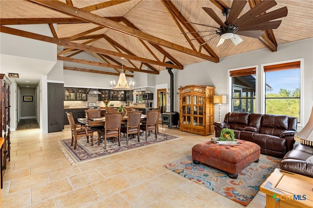 living area with wood ceiling, ceiling fan with notable chandelier, high vaulted ceiling, and beamed ceiling