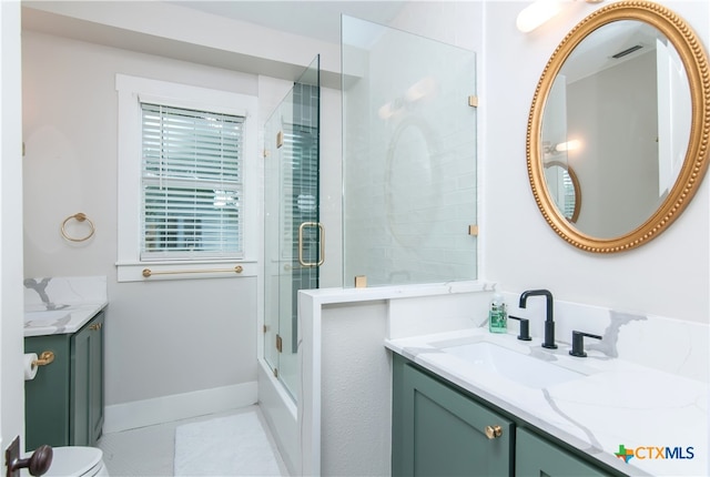 bathroom featuring toilet, vanity, and tile patterned flooring