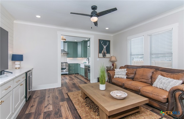 living room with ceiling fan, dark hardwood / wood-style floors, sink, and crown molding