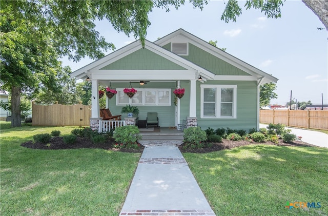 view of front of home with a front yard and covered porch