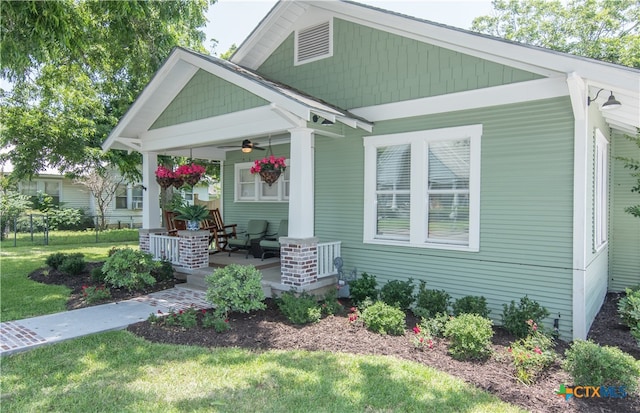 view of front of property with a porch, a front lawn, and ceiling fan