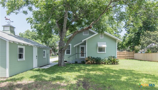 back of house featuring a yard