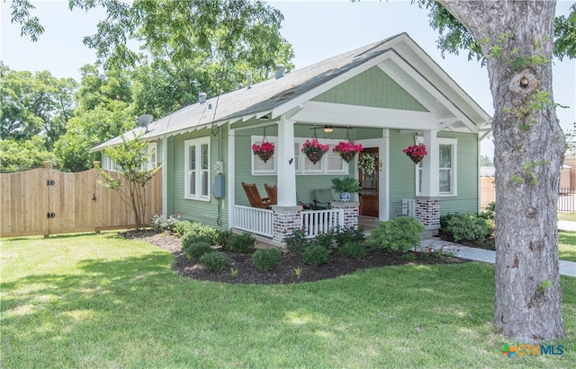 view of front of house featuring a front yard and covered porch