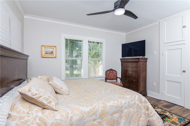 bedroom with wood-type flooring, ceiling fan, and crown molding