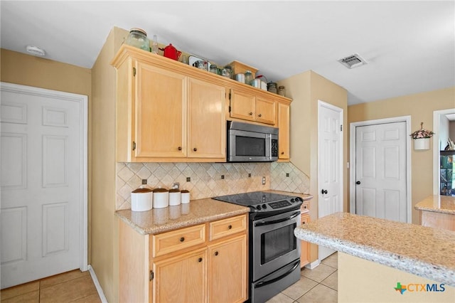 4 Longview Dr, Victoria, TX 77904 - kitchen featuring appliances with stainless steel finishes, light tile patterned flooring, light brown cabinets, decorative backsplash, and light stone countertops
